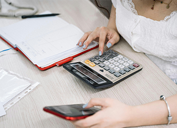A calculator and financial documents representing loan calculations.